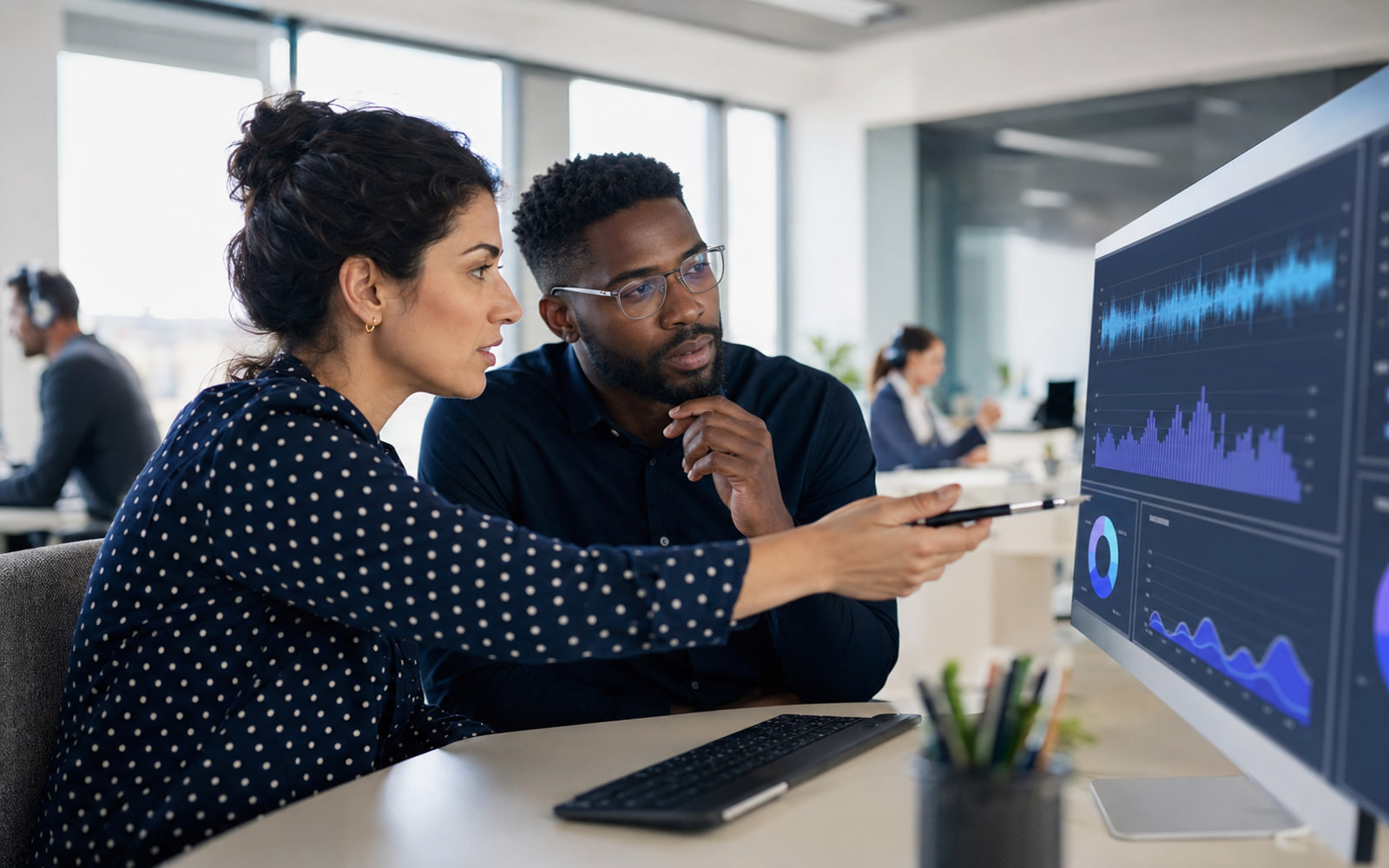 Quality team reviewing scored conversations on a shared screen